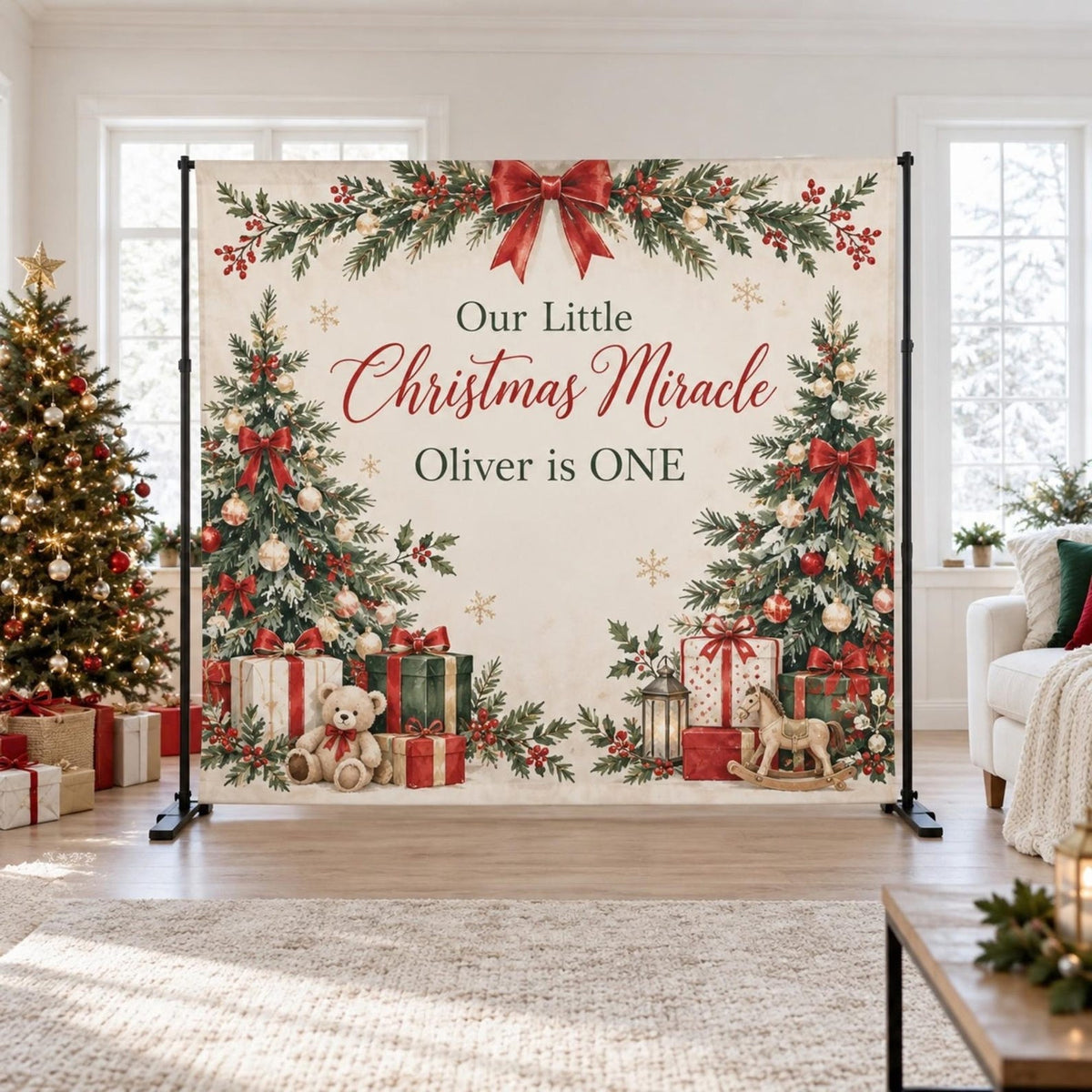 Our Little Christmas Miracle first birthday backdrop with evergreen branches, a red bow and gifts.