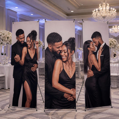 Three personalized wedding photo banners on X-stands displayed at a reception.