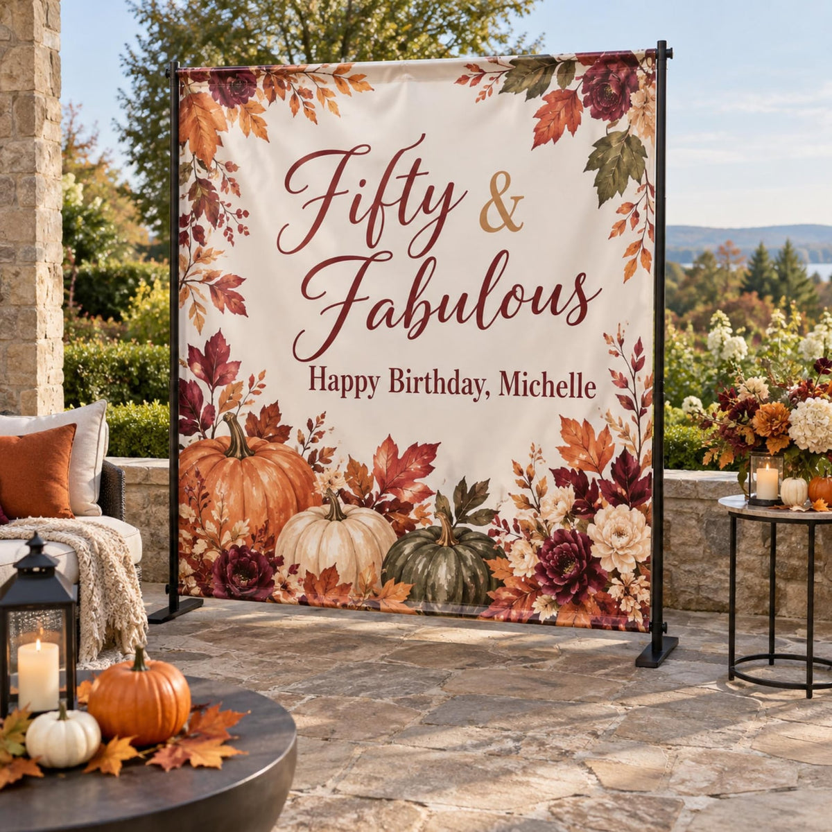 Fifty and Fabulous fall birthday backdrop with pumpkins and autumn flowers on a patio.