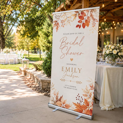 Autumn bridal shower banner with orange leaves and personalized name, displayed outdoors.