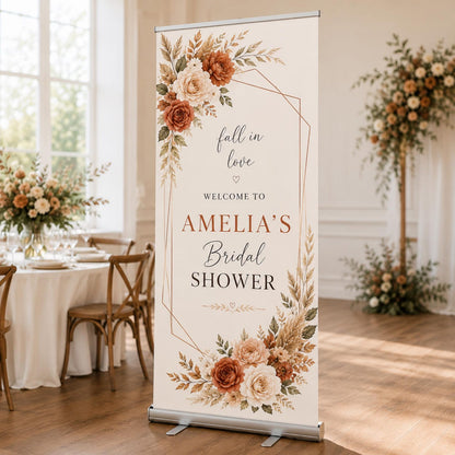 Fall in Love bridal shower welcome banner with cream background and orange floral corners.