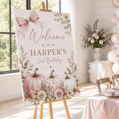 Harper's second birthday welcome sign with a mauve bow, pastel pumpkins and floral border.