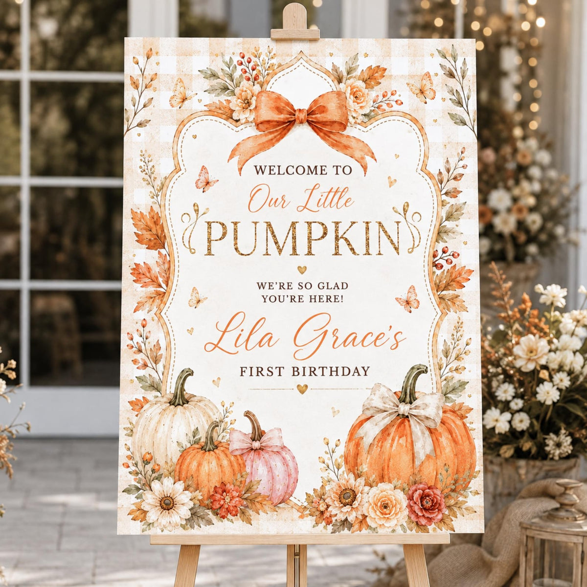Orange Our Little Pumpkin first birthday welcome sign with an autumn bow, pumpkins and daisies.