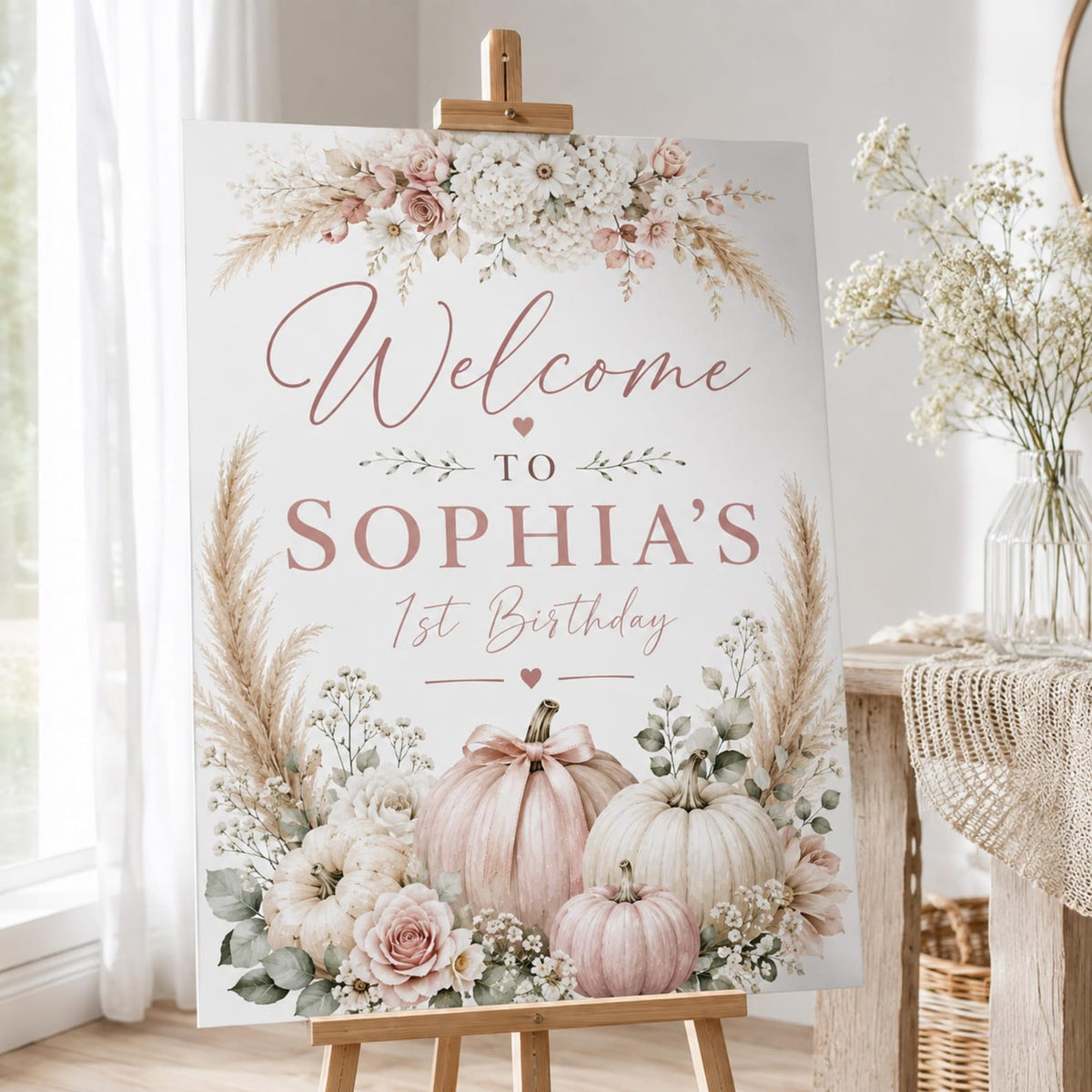 Sophia's first birthday welcome sign with blush pumpkins and soft floral arrangements.