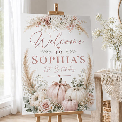 Sophia's first birthday welcome sign with blush pumpkins and soft floral arrangements.
