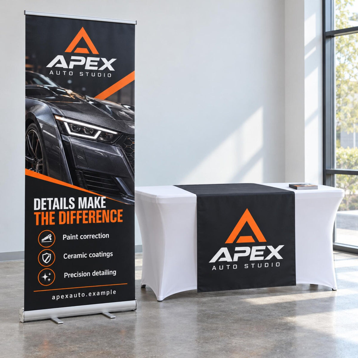 Apex Auto Studio banner and black vinyl table runner