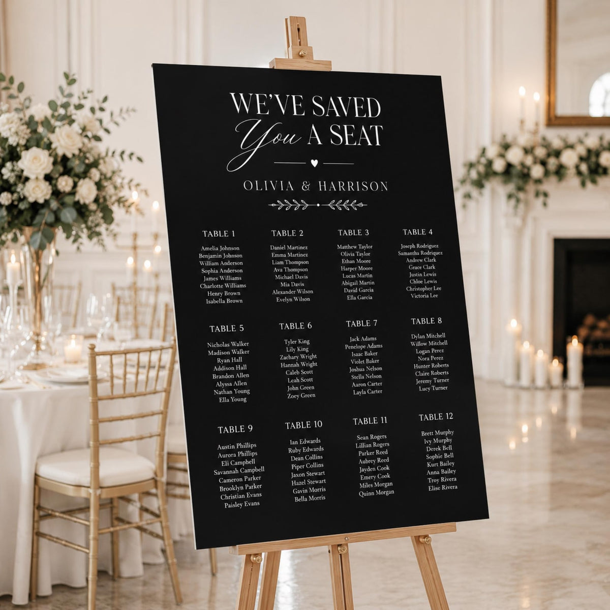 Black minimalist wedding seating chart on an easel